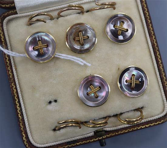 A cased set of early 20th century five (ex 6) 18ct and shell set dress studs.